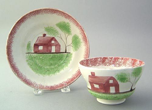 Red spatter cup and saucer with red schoolhouse.