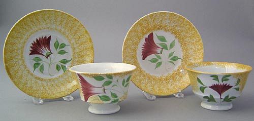 Yellow spatter cup and saucer with red thistle, to