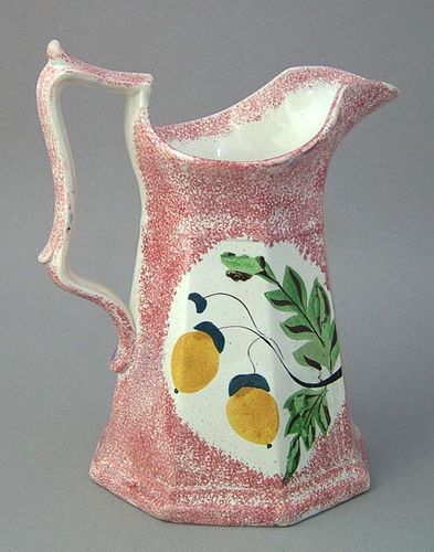 Red spatter paneled pitcher with double sided yell