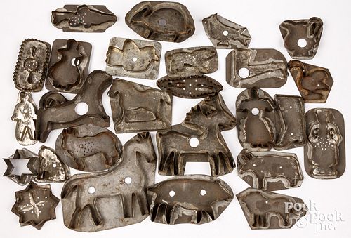 Collection of twenty-six tin cookie cutters
