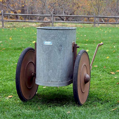 A mobile water hopper, or barrel, with copper wheels