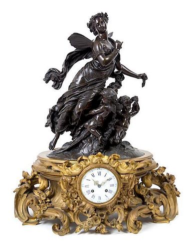 A French Gilt and Patinated Bronze Mantel Clock Height 29 1/2 inches.