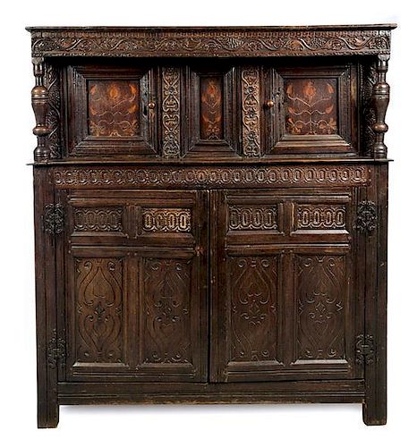 * A Jacobean Carved Oak Court Cupboard Height 63 x width 56 x depth 25 inches.