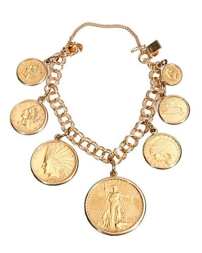 A gold coin and 14k gold charm bracelet