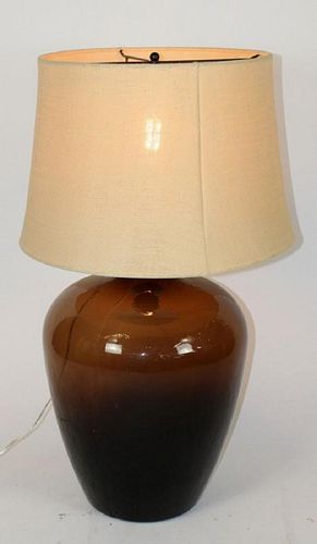 Amber glass wine bottle mounted as lamp