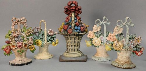 Group of five cast iron basket door stops, four flower and one fruit. hts. 9 3/4in. to 14 1/2in.