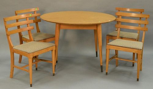 Modern oak table and four chairs plus two 12" leaves. ht. 29in., dia. 44in., total open: 44" x 67"