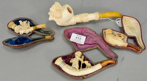 Four carved Meerschaum pipes including nude woman, boy with goat, deer, and bird in a nest with an egg. lg. 3 1/2in. to 8 1/2