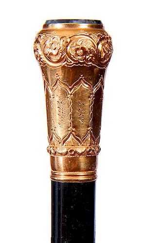 25. Gold Dress Cane- Dated 1875- An ornate unsigned 14 kt gold handle with a black and white quartz disc atop, inscribed “R