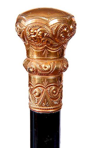 26. Gold Dress Cane- Ca. 1900- A large gold filled ornate handle with a script initial on top, thick ebony shaft and a metal 