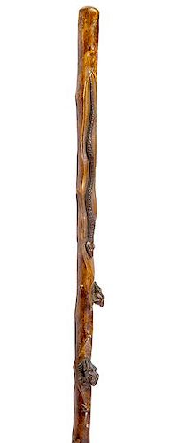 38. Frog and Snake Folk Art Cane- Ca. 1920- A one piece carved hardwood shaft with a 10” snake with two color glass eyes, r