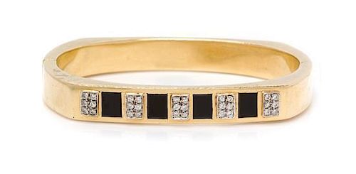 * A 14 Karat Yellow Gold, Onyx and Diamond Bangle Bracelet. 19.85 dwts.