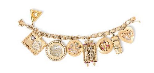 A 14 Karat Yellow Gold Bracelet with Eight Attached Charms, 40.80 dwts.