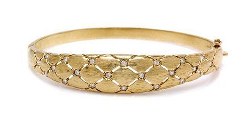 * A 14 Karat Yellow Gold and Diamond Bangle Bracelet, 14.35 dwts.