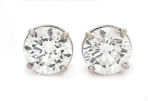 * A Pair of White Gold Diamond Stud Earrings, 0.90 dwts.