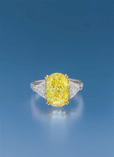A Platinum, Yellow Gold, Fancy Yellow Diamond and Diamond Ring, 4.40 dwts.