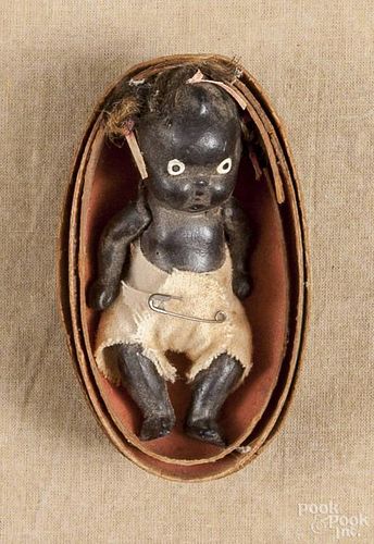 Japanese bisque black Americana jointed doll, early 20th c., in a cardboard watermelon, 4'' l.