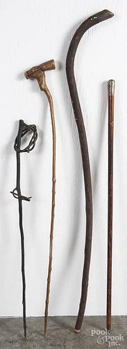 Four walking sticks, 19th/20th c., one with a sterling silver cap.