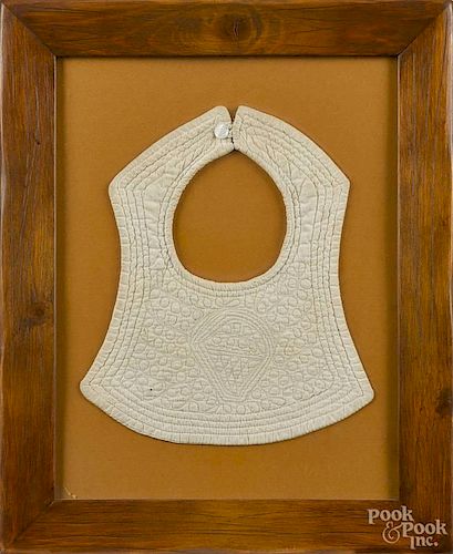Child's quilted bib, 19th c., with intricate machine stitched quilting, 9'' h.