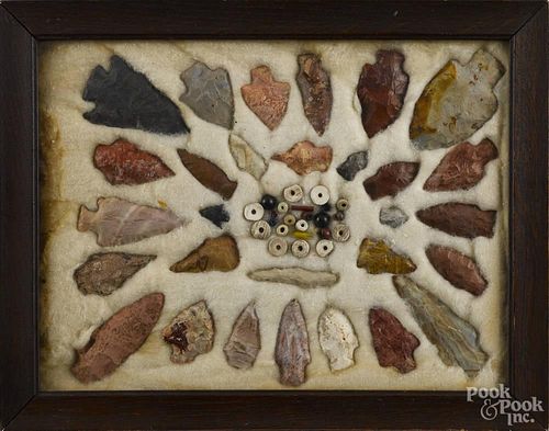 Framed group of arrowheads and trade beads, largest - 3'' l.