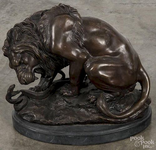 Recast bronze lion and snake sculpture, 20th c., 13'' h., 15 1/2'' w.