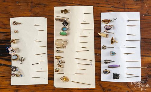 Thirty-two stick pins with various motifs, to include gold, gold-filled, and silver