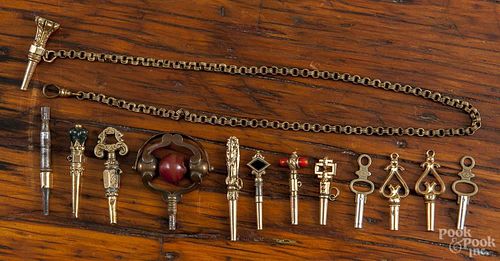Thirteen various watch keys, some containing accent stones, one gold-filled chain, gold-filled