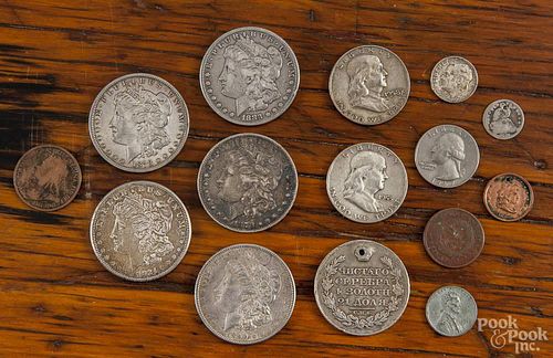 Fifteen coins, to include silver dollars, half dollars, quarters, etc., primarily US coins.