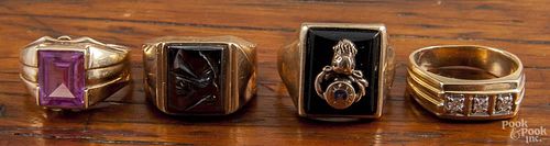 Four men's 10K yellow gold rings, to include black onyx, diamond, etc., 20.3 dwt total.