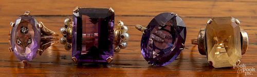 Four unmarked gold rings with large stones, such as citrine and amethyst, etc., 21.7 dwt total.