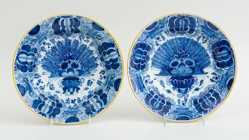 TWO SIMILAR DUTCH BLUE AND WHITE DELFT PEACOCK PLATES