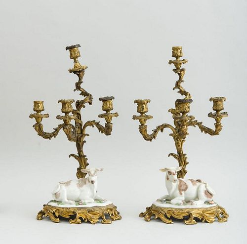 PAIR OF LOUIS XV STYLE GILT-BRONZE FOUR-LIGHT CANDELABRA, FITTED WITH CONTINENTAL PORCELAIN FIGURES OF SEATED COWS