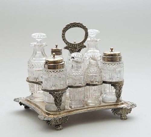 REGENCY SILVER CRUET FRAME FITTED WITH FOUR SILVER-LIDDED GLASS CRUETS AND FOUR CUT-GLASS BOTTLE STOPPERS