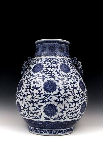 A Chinese Blue & White Pear Shaped Vase with Archaic Pierced Handles from the Qing Dynasty with a Six-Character Qianlong Mark on the Base.

H: Approxi