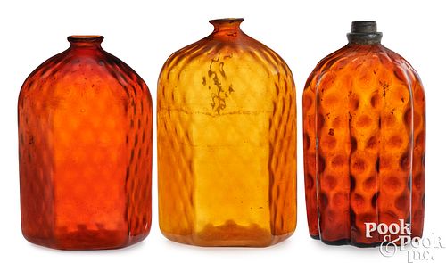 Three blown amber glass bottles, 19th c.