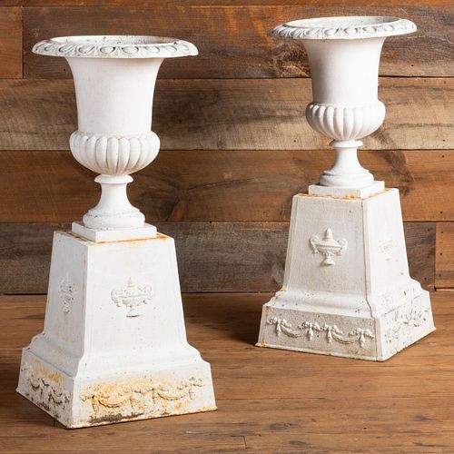Pair of White Painted Cast-Iron Garden Urns on Pedestals