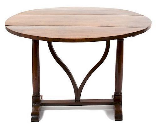 A Continental Provincial Style Walnut Tilt-Top Table Height 28 1/2 x diameter 42 inches.