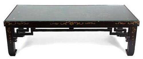 A Black and Gilt Lacquered Low Table Height 16 x width 51 1/2 x depth 24 1/2 inches.