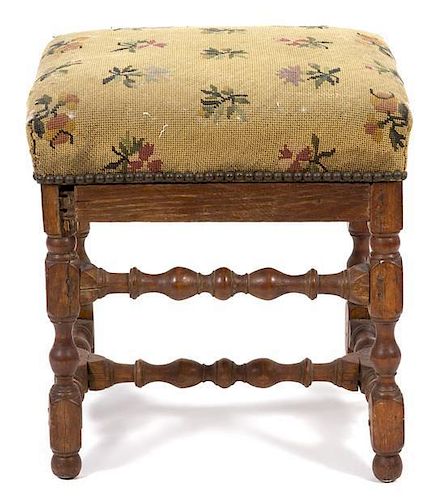 A Jacobean Style Footstool Height 18 x width 17 1/2 x depth 15 1/2 inches.