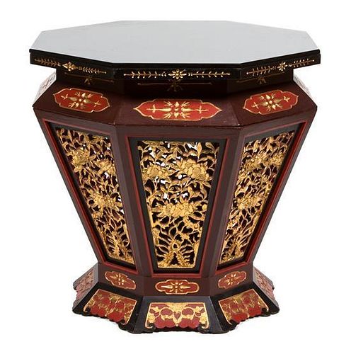 A Chinese Lacquered and Gilt Carved Drum Table Height 29 1/2 x diameter 33 inches.