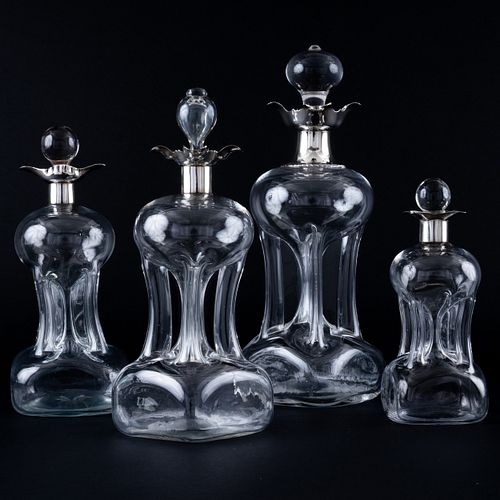 Group of Four English Silver-Mounted Glass Decanters