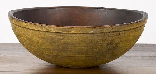 Massive turned bowl, 19th c., retaining an old mustard surface, 9'' h., 24 1/4'' dia.