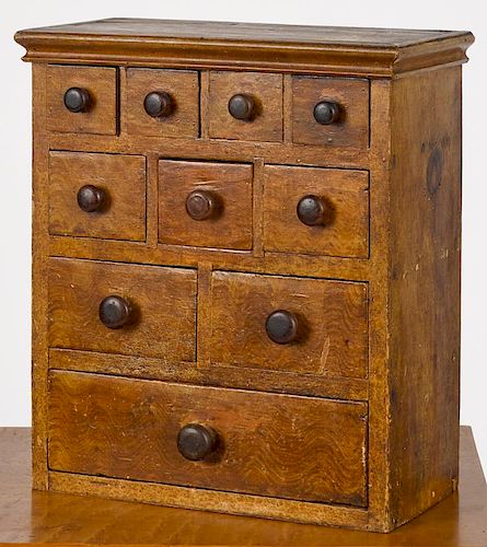 Painted pine apothecary cabinet, 19th c., retaining its original ochre swirl and grain decoration,