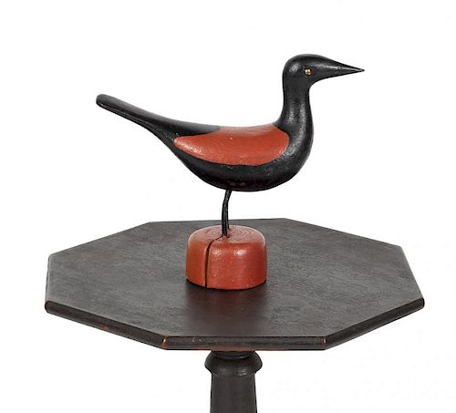 Carved and painted bird, early/mid 20th c., retaining its original red and black surface, 9'' h.