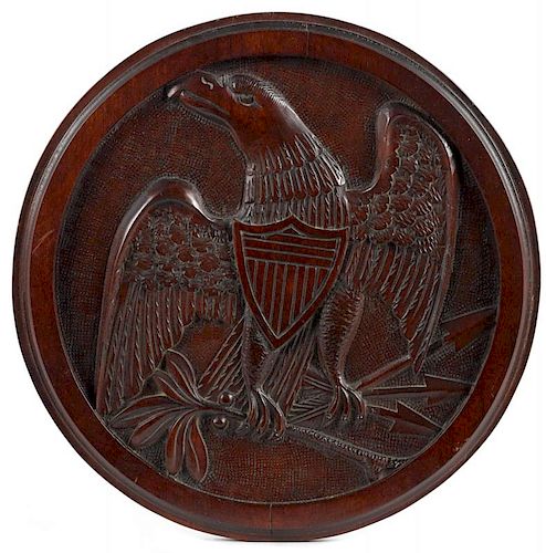 Carved mahogany plaque, early 20th c., with an American eagle, 13 5/8'' dia. Provenance: New Jersey