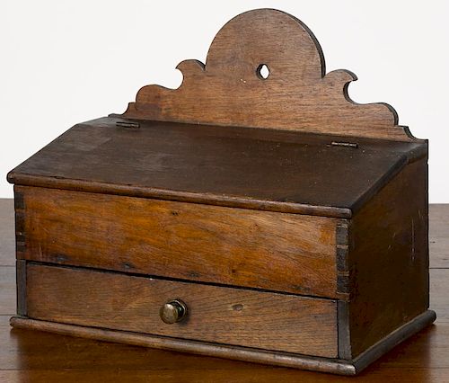 Pennsylvania walnut hanging box, 19th c., with scalloped backsplash, slant lid and single drawer,