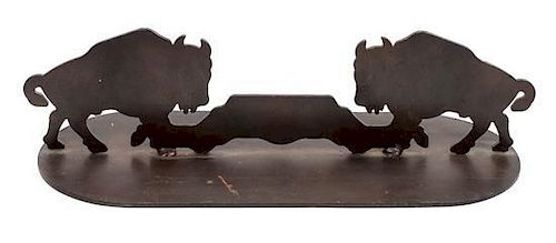 A Pair of Iron Door Stops Depicting Bison in Profile Each height 5 3/4 x width 21 x depth 8 inches.