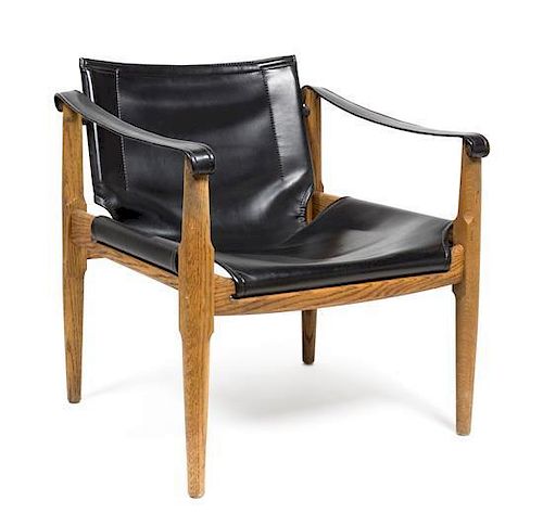 An Oak and Black Leather Safari Chair Height 27 1/2 x width 25 x depth 24 1/2 inches.