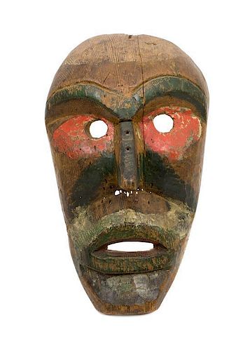 A Kwakwaka'wakw Painted Carved Wood Mask Height 4 1/2 x length 11 1/5 x width 7 inches.