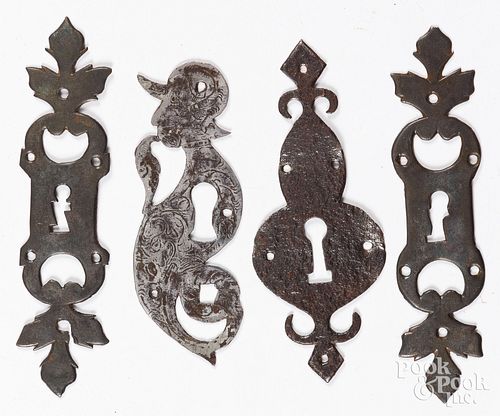Four wrought iron keyhole escutcheons, 19th c., ta